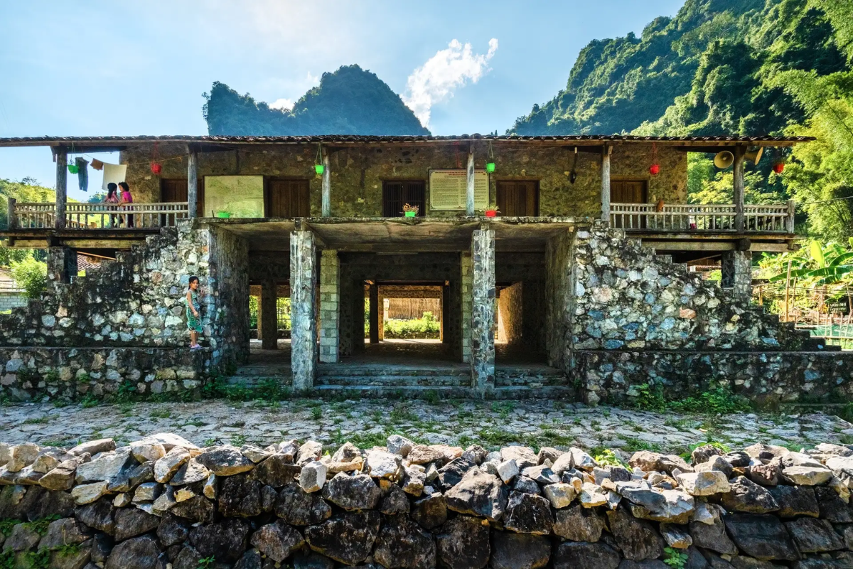 Traditional Tay stone stilt house in Khuoi Ky village with wooden frames and flagstone base